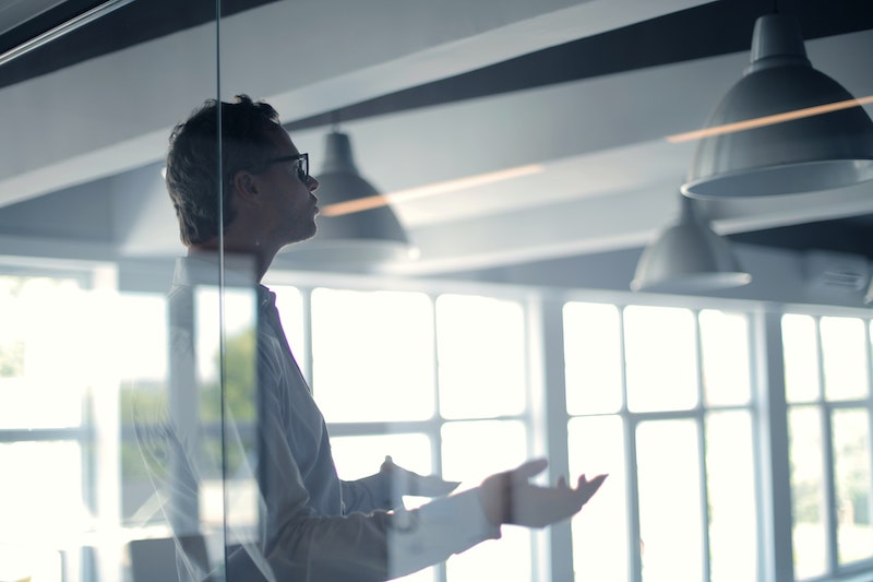A young Black woman leads her team in a project meeting
