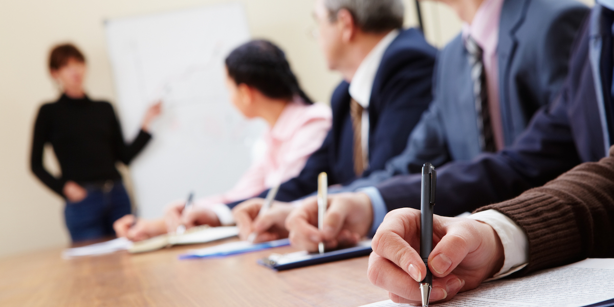 A young Black woman leads her team in a project meeting
