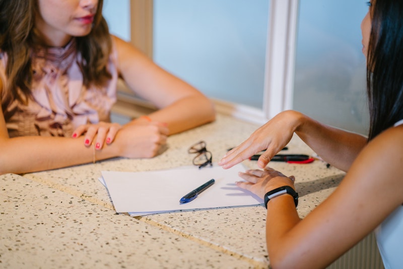 A young Black woman leads her team in a project meeting