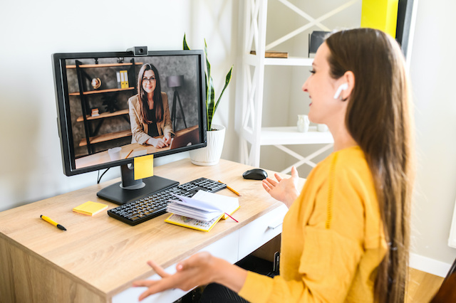 Two female coworkers meet informally by videoconference.