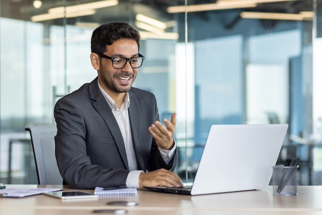 Man in glasses coaches a job seeker virtually.