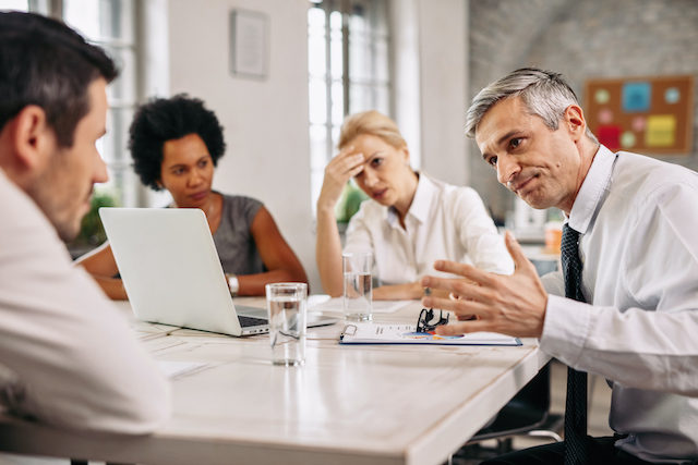 a layoff notification meeting taking place in an office