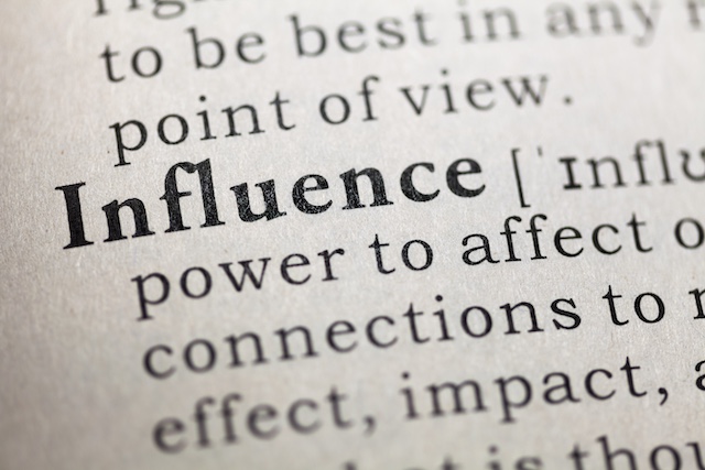 A young Black woman leads her team in a project meeting