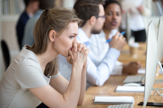 A young Black woman leads her team in a project meeting