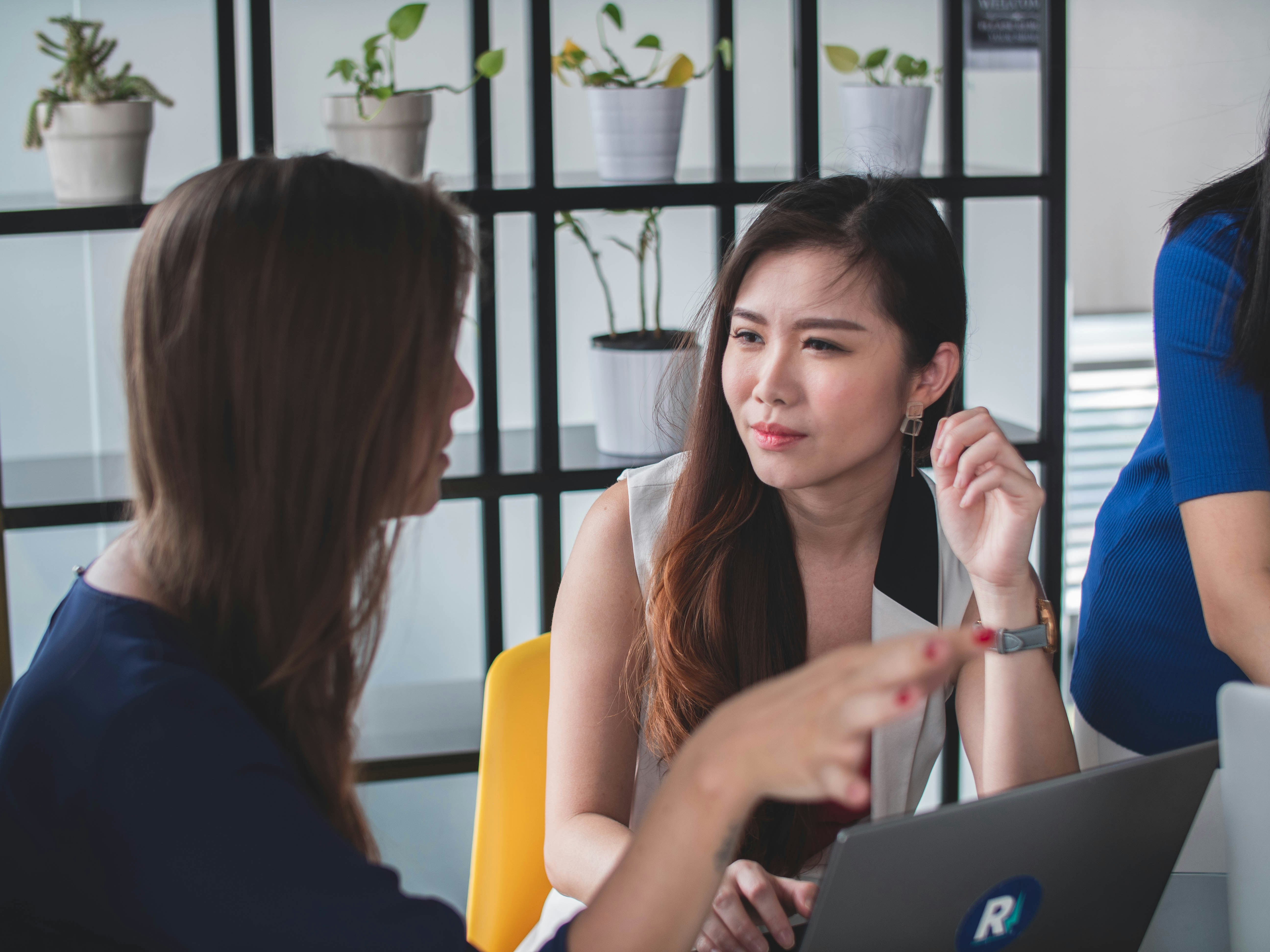 A young Black woman leads her team in a project meeting