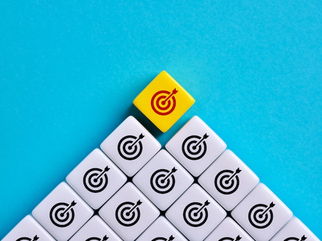 A young Black woman leads her team in a project meeting