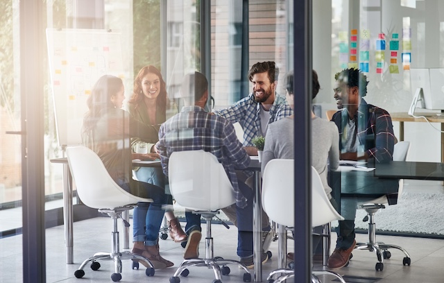 A young Black woman leads her team in a project meeting