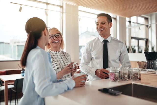 A young Black woman leads her team in a project meeting