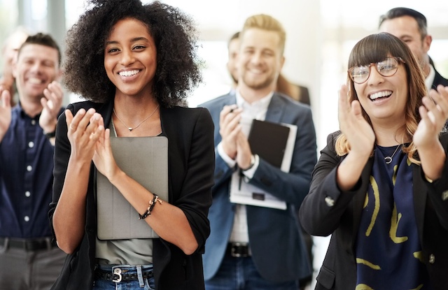 A young Black woman leads her team in a project meeting
