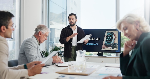 A leadership team reviews AI policies in a boardroom.