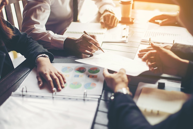 A group of businesspeople review financial reports