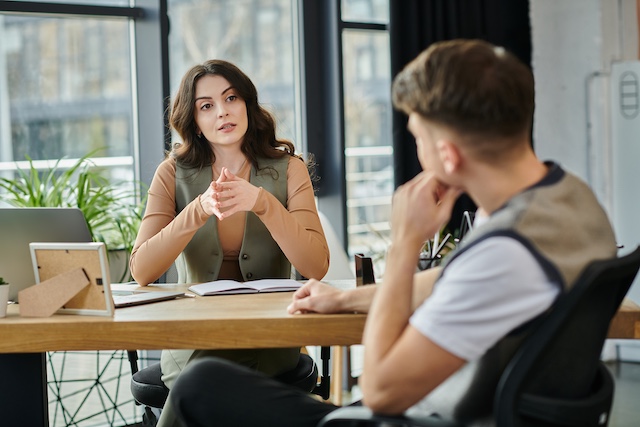 A female HR manager reviews outplacement and severance with an employee during a layoff